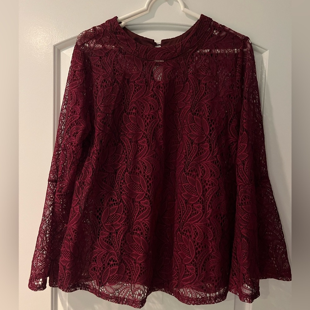 Burgundy lace top, long sleeves, with built in camisole. Button at back.